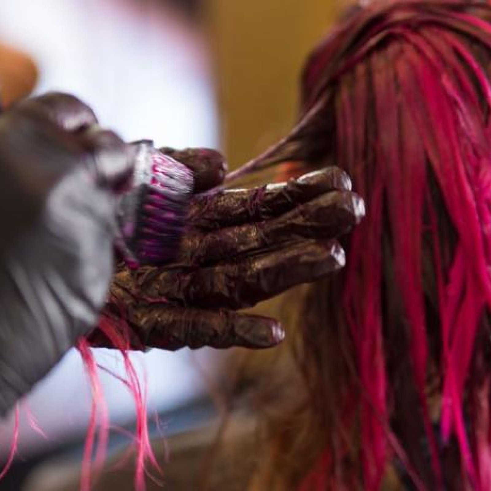 hair-dresser-dying-a-woman-s-blond-hair-pink
